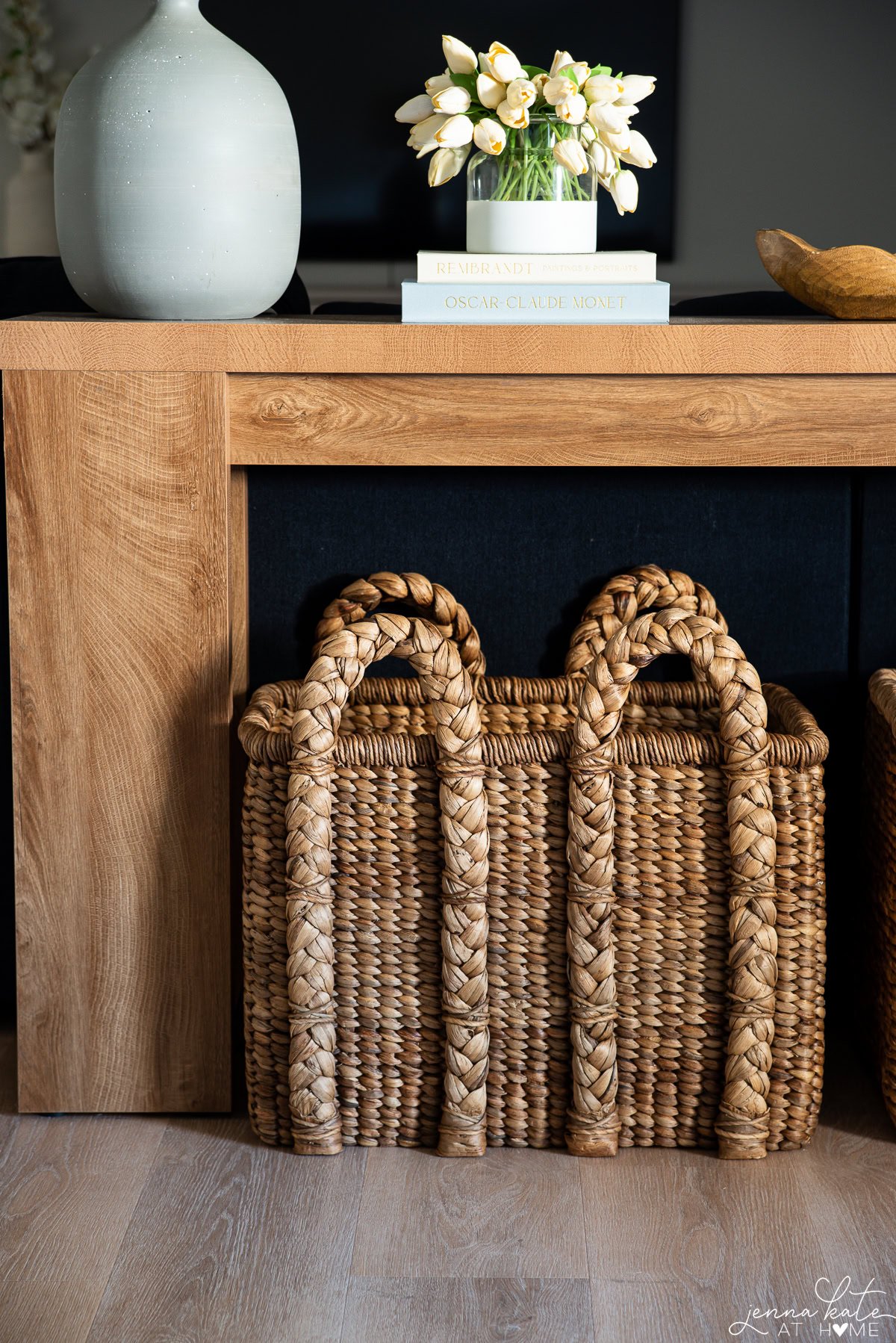 Tall woven storage baskets placed beneath a console table for functional styling.