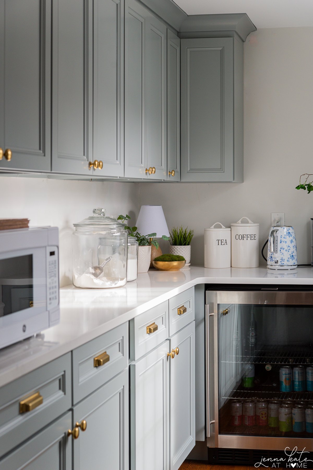 Butler's pantry with Benjamin Moore Boothbay Gray cabinets, brass hardware and white countertops.