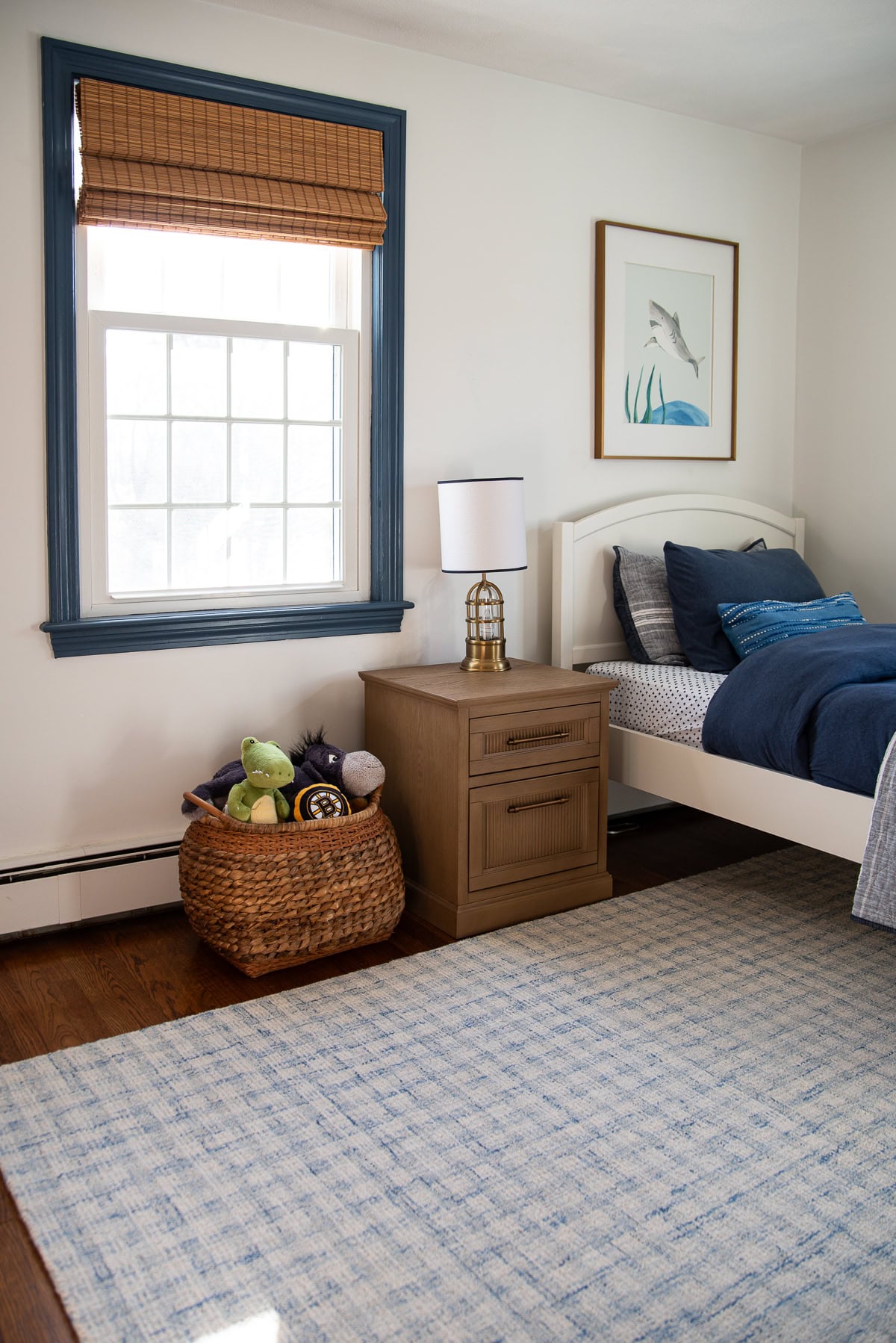 Bedroom with Sherwin Williams Pure White walls and BM Van Deusen Blue window trim.