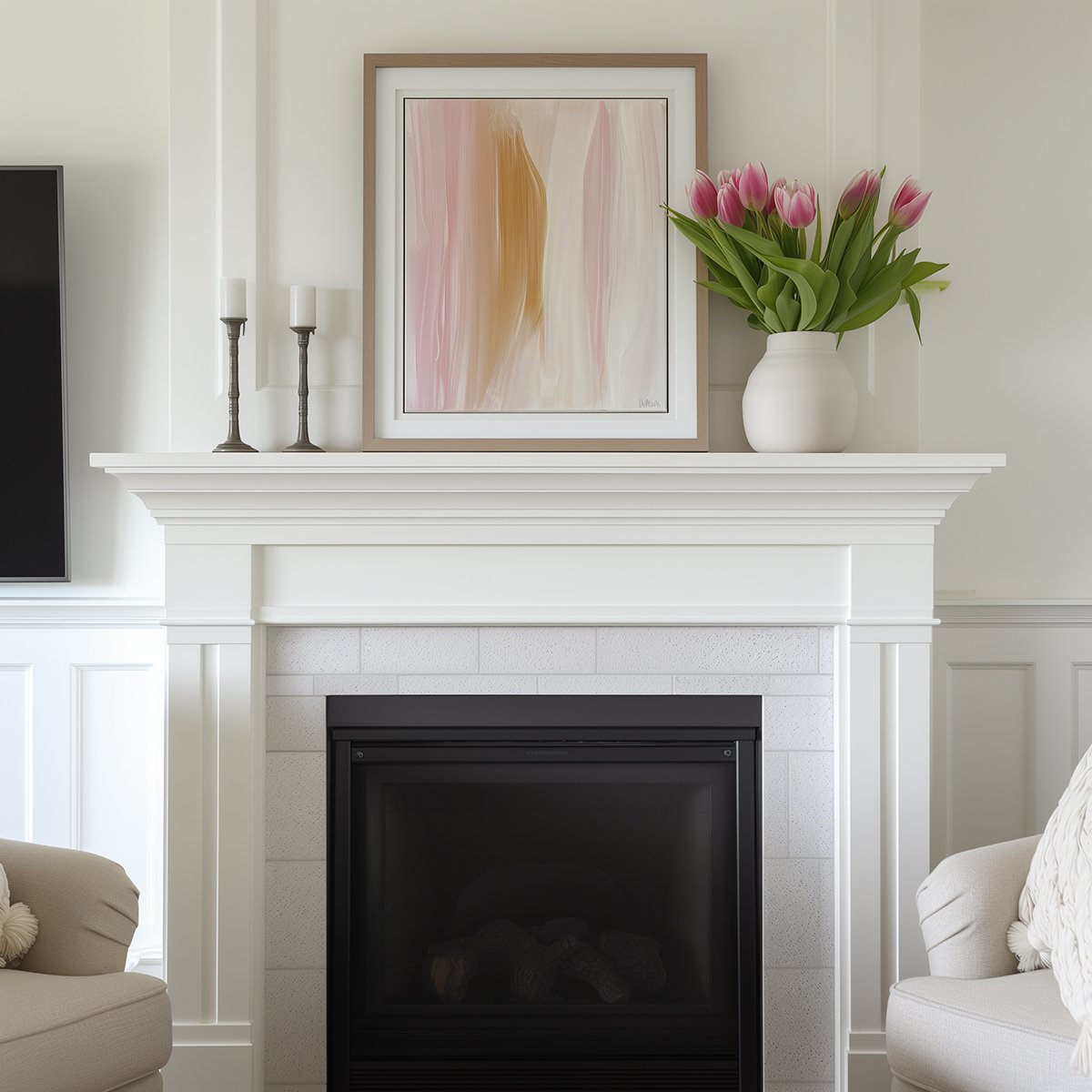 classic white fireplace mantel with pink abstract art, a vase of pink tulips and two candleholders.