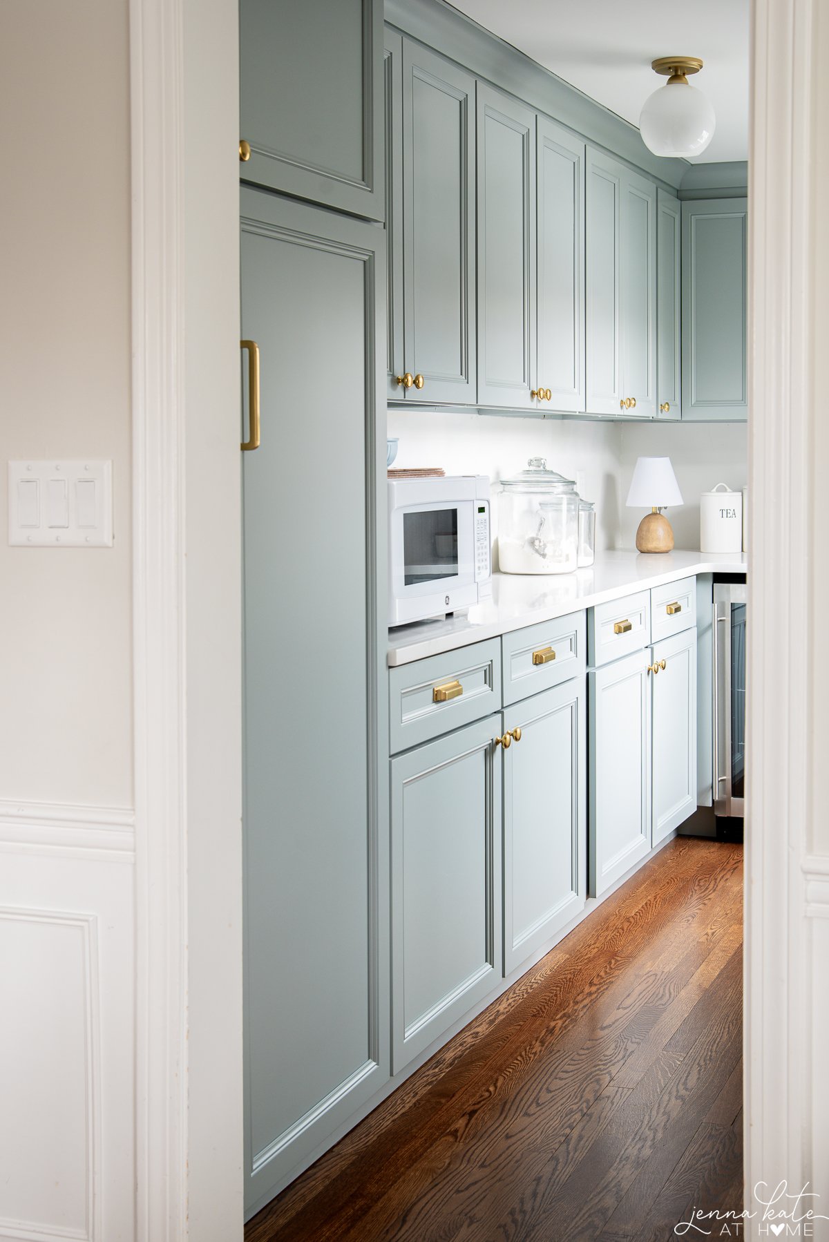 walk in pantry with blue cabinets.