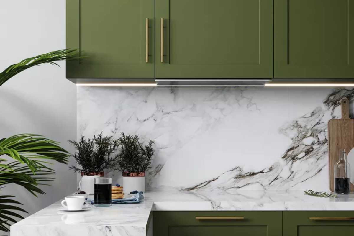 marble backsplash in a kitchen with olive green cabinets.