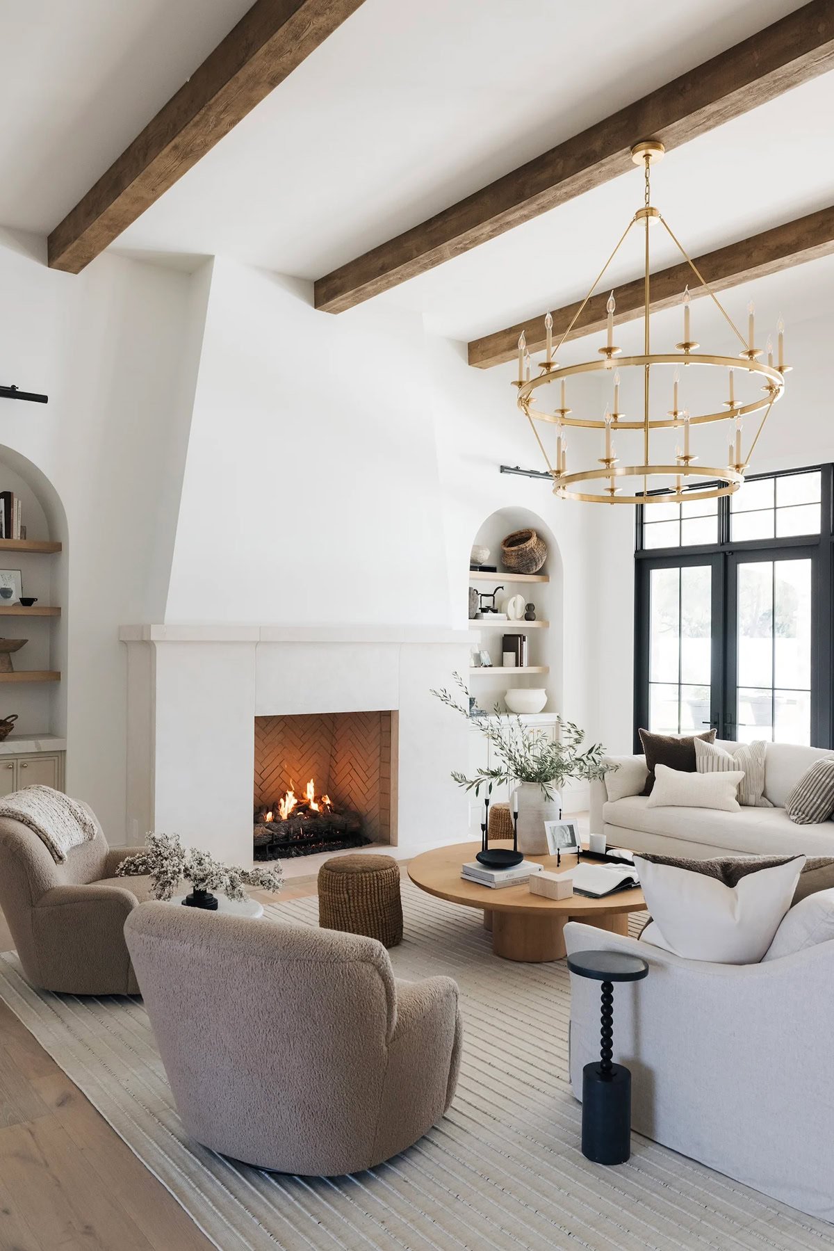 modern living room with white walls, ceiling beams and neutral furniture.