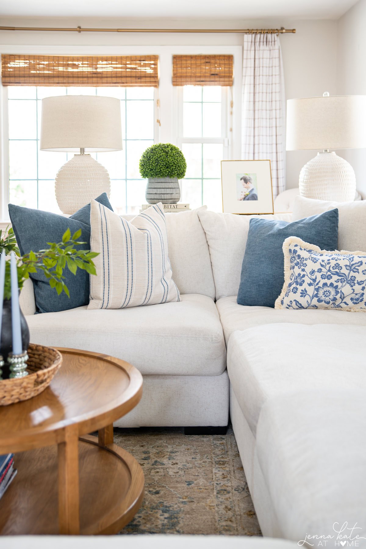 living room with white couch and blue throw pillows.