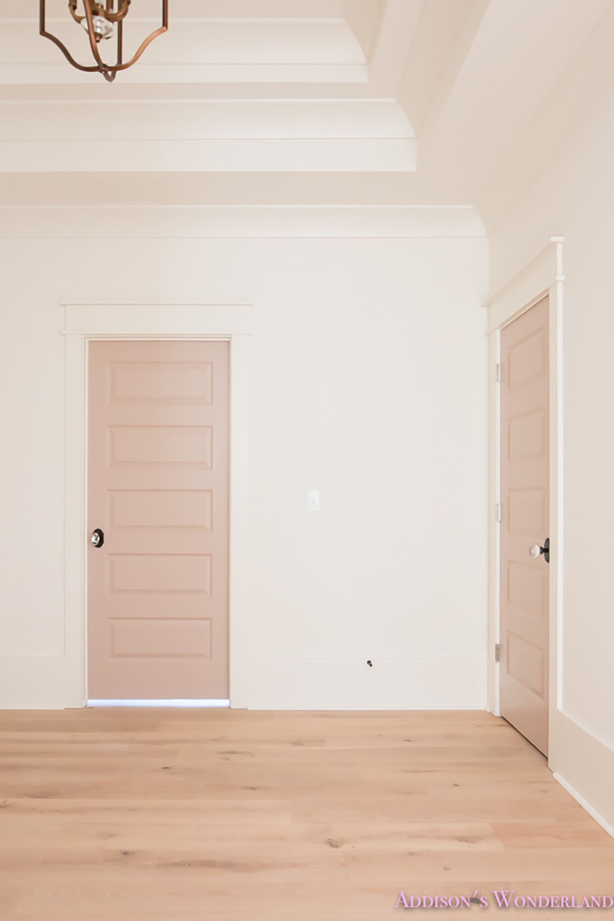 Sherwin Williams Doeskin painted on the doors as an accent of a girls playroom.