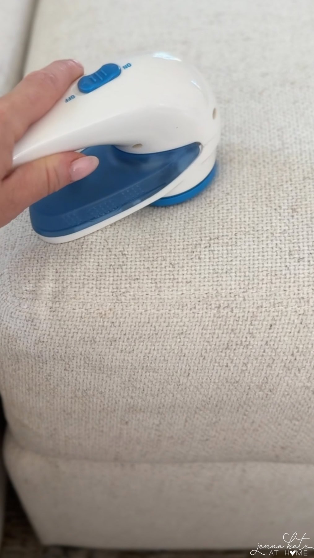 Fabric shaver removing pills from a couch cushion.