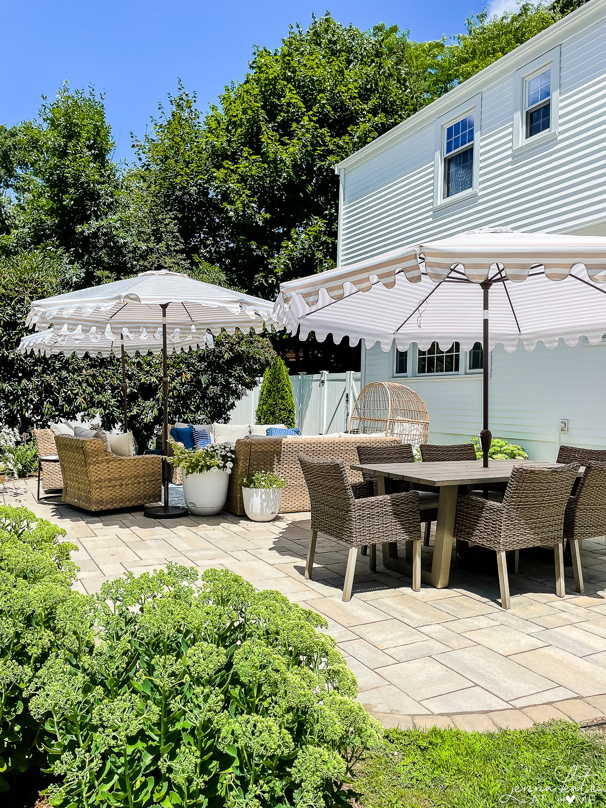 large patio with both a seating area and a dining area.