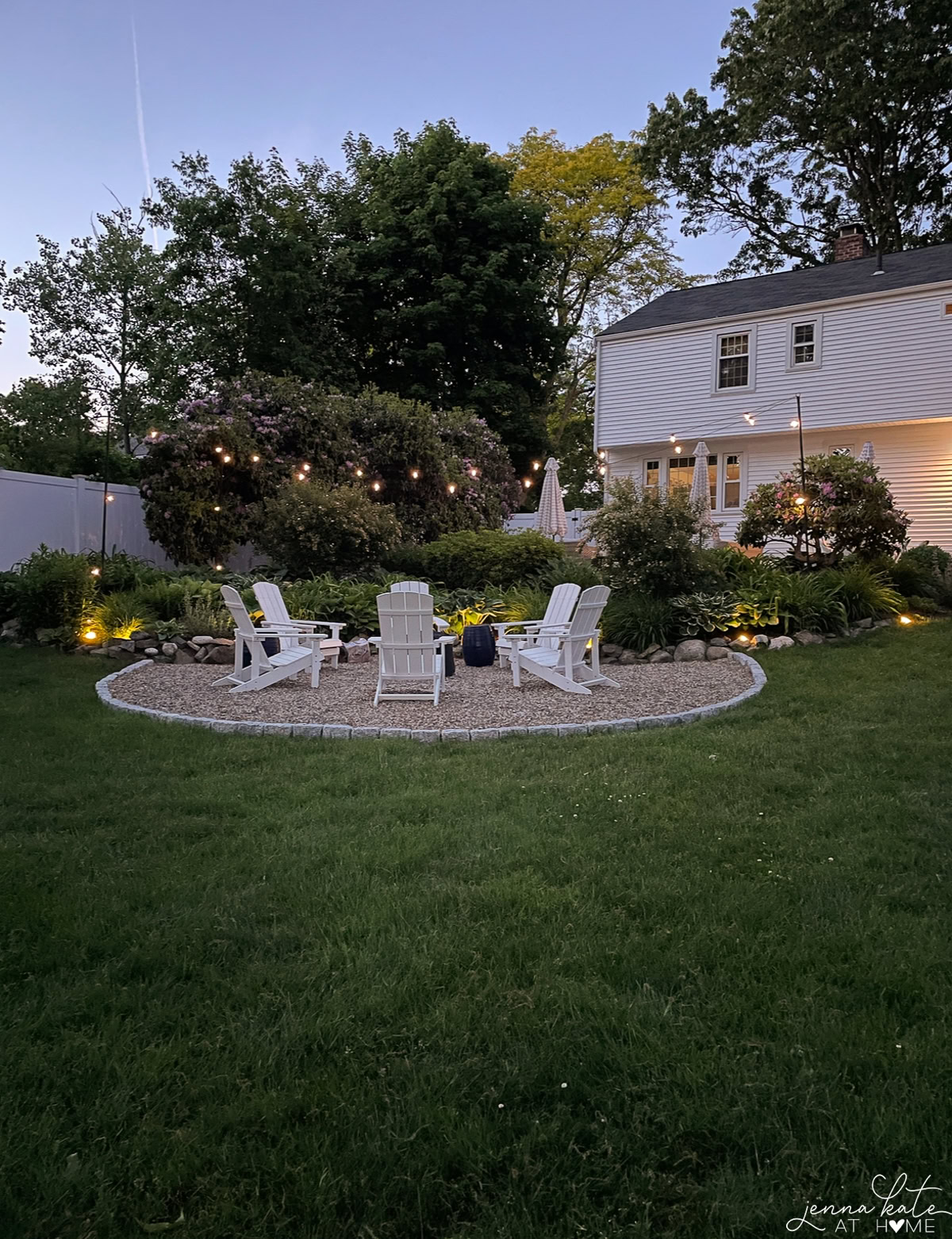 firepit area with string lights on at night.