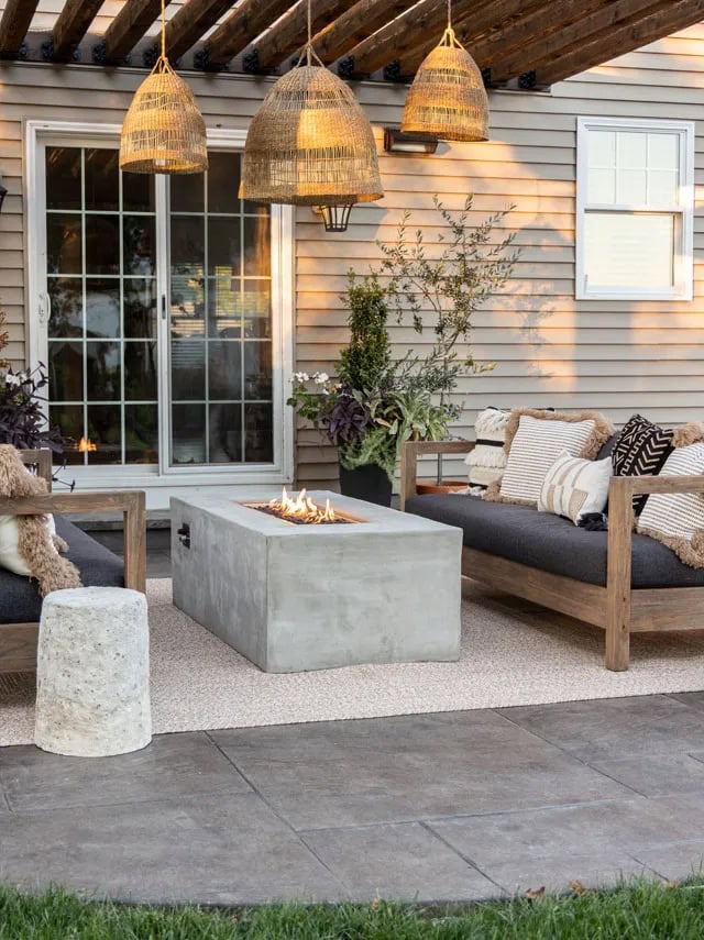 rectangular concrete firepit table on a patio.