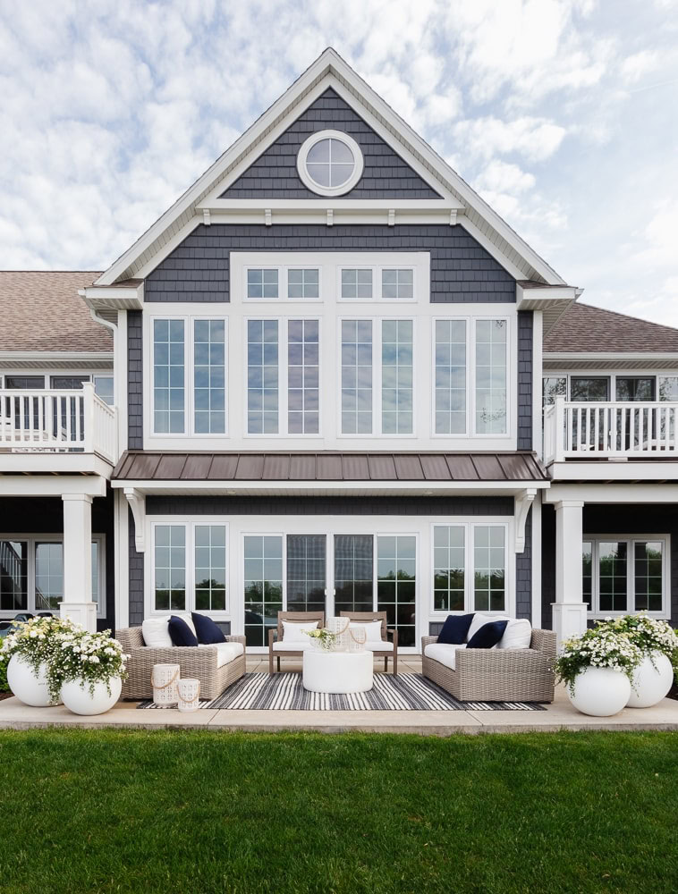 large navy house with a patio area right outside the sliding doors.