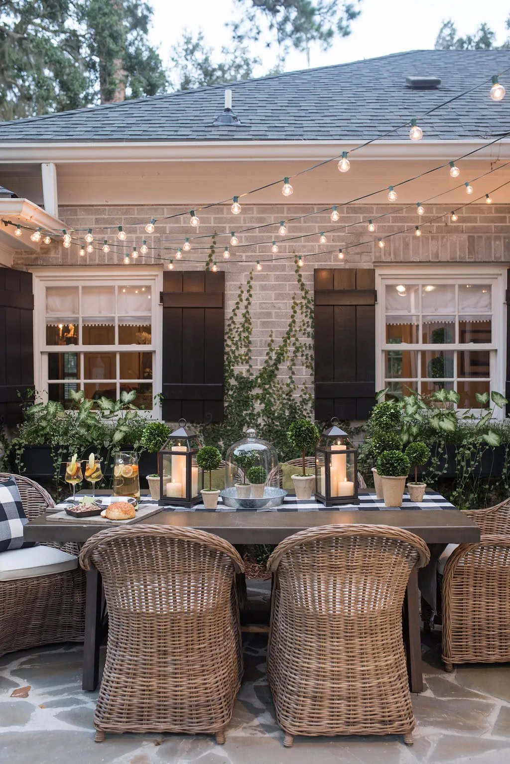 string lights hanging over an outdoor dining table.