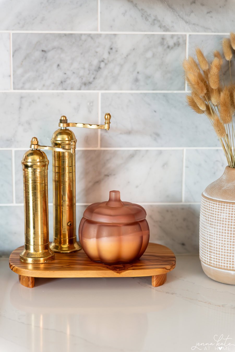 brass salt and pepper mills and a fall pumpkin shaped candle.