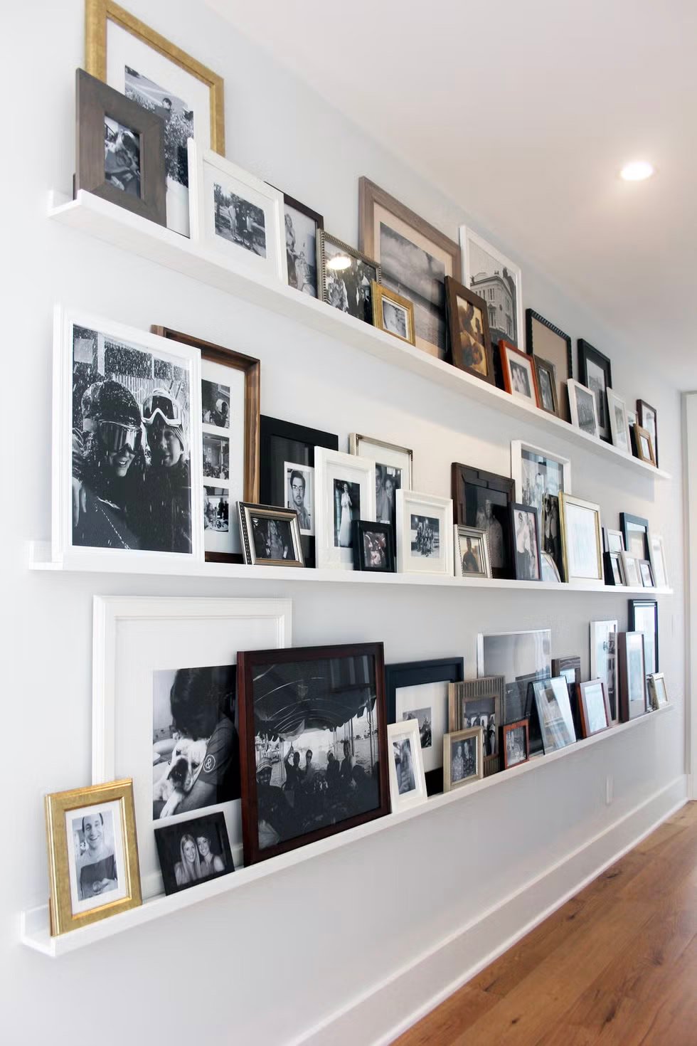 book ledge display of family photos.