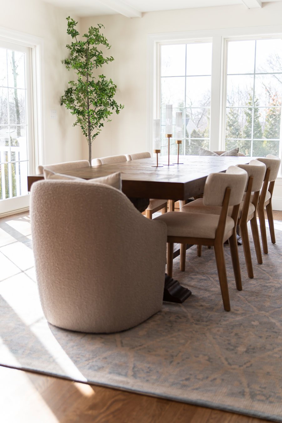 Dark wood dining room table with contrasting chairs.