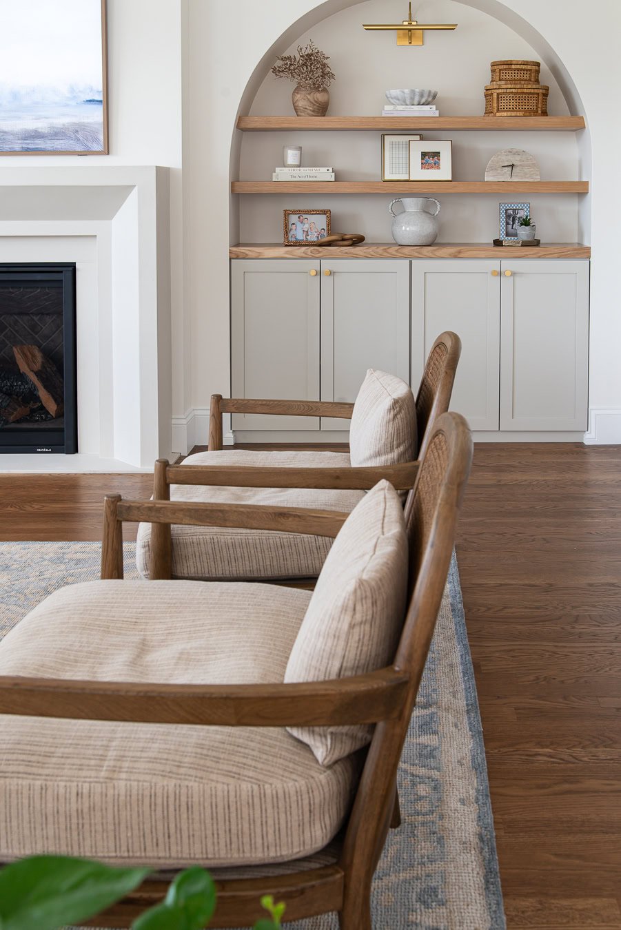 Arched built-ins in the family room with base cabinets painted Benjamin Moore Revere Pewter.