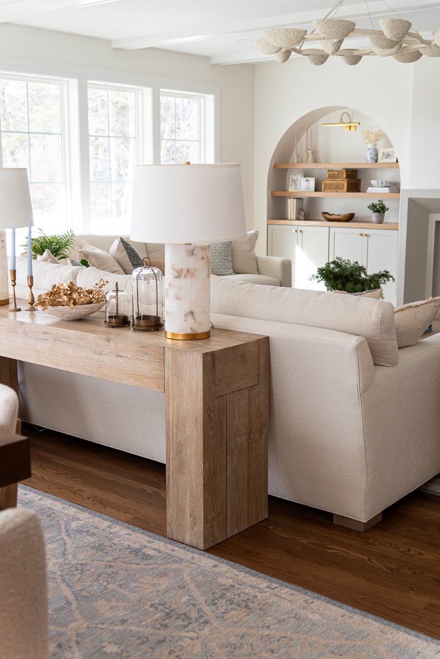 Console table behind the couch with lamps that plug in to the floor.