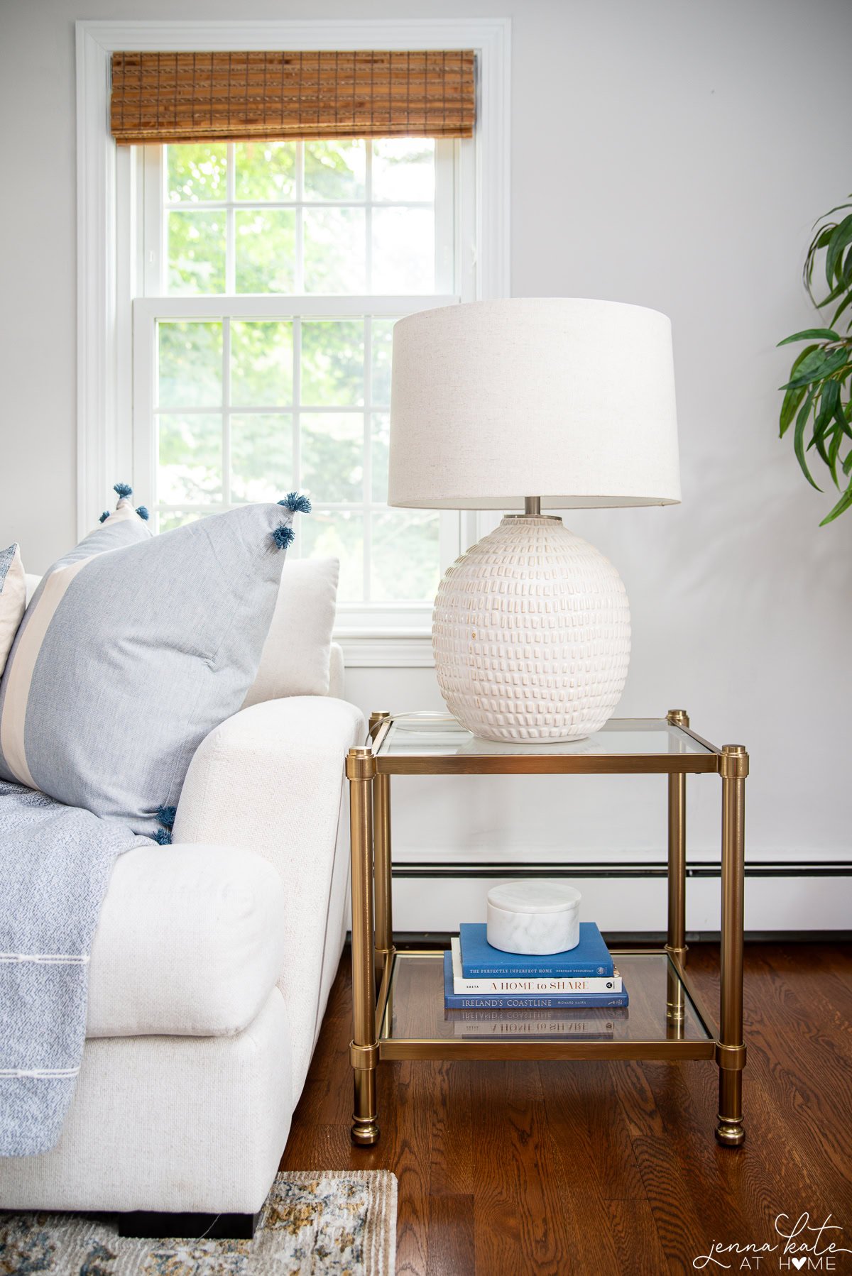New side table that's brass and glass and works well with the other finishes.